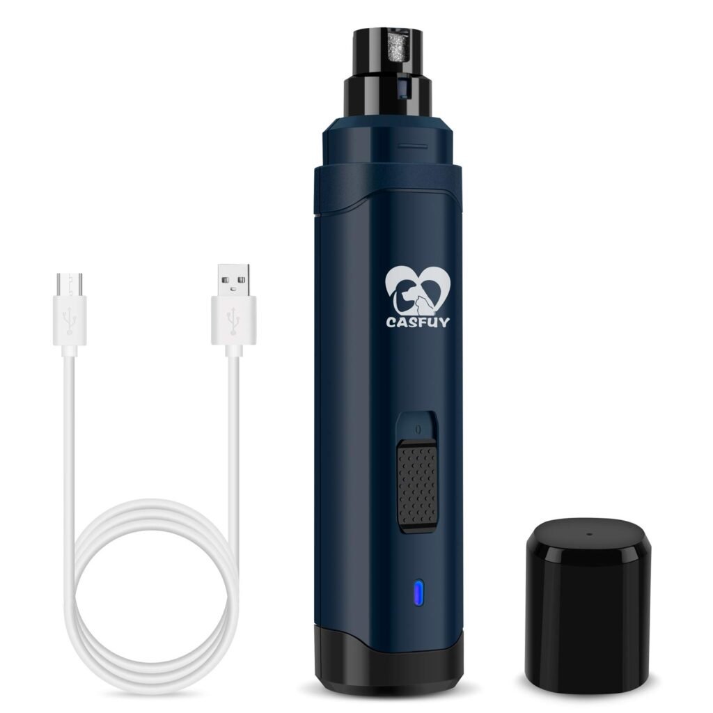 Casfuy rechargeable dog nail grinder on a counter beside a grooming brush