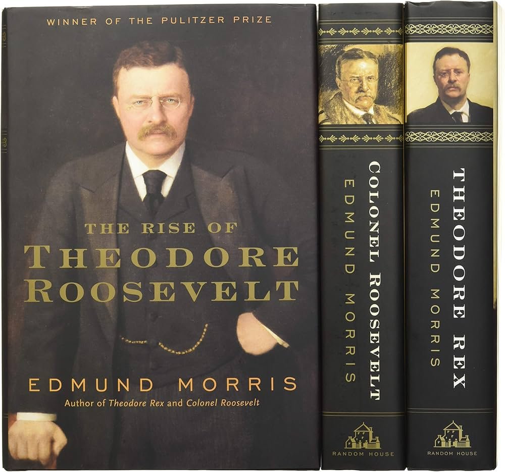 Spines of the Theodore Roosevelt Trilogy by Edmund Morris on a bookshelf