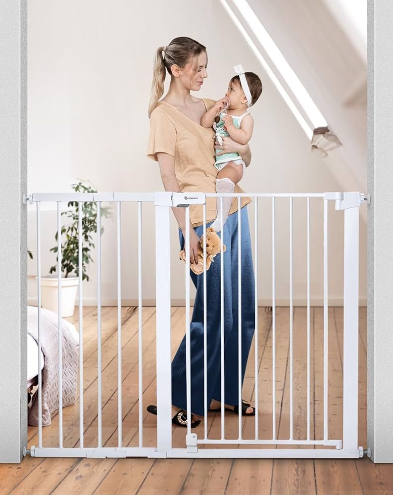 Extra tall COMOMY baby gate with auto-close latch mounted across a wide stair opening in a home