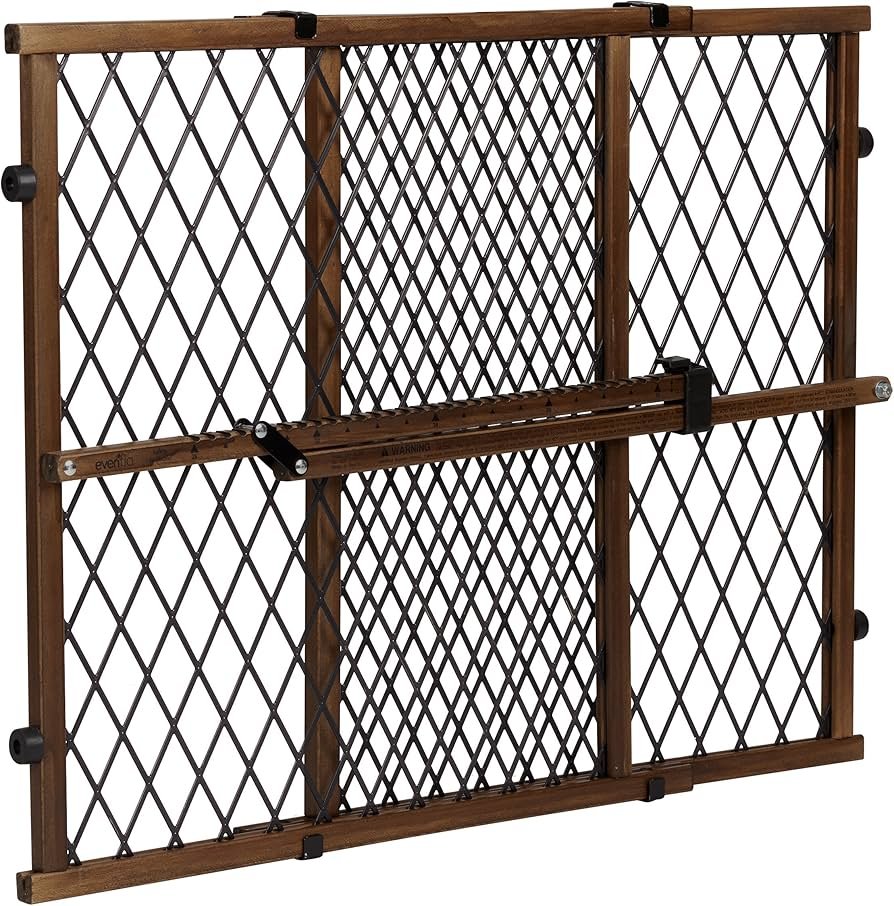 Evenflo farmhouse-style pressure baby gate positioned in a doorway with wood-tone accents