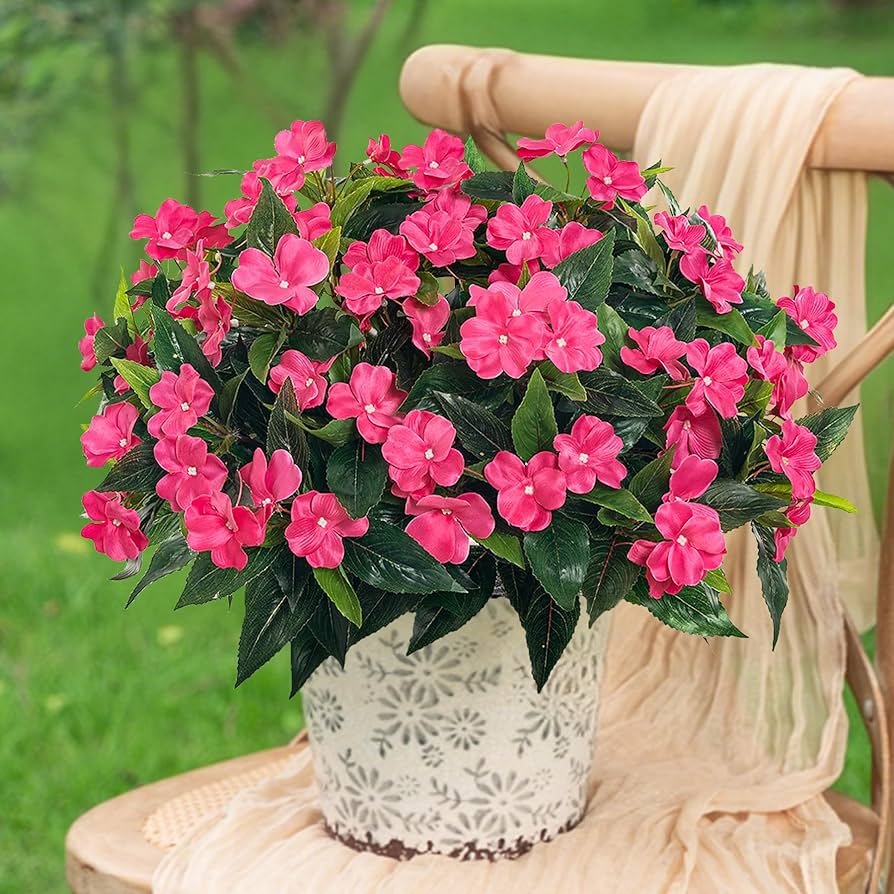Impatiens hanging basket with dense pink blooms in shaded patio
