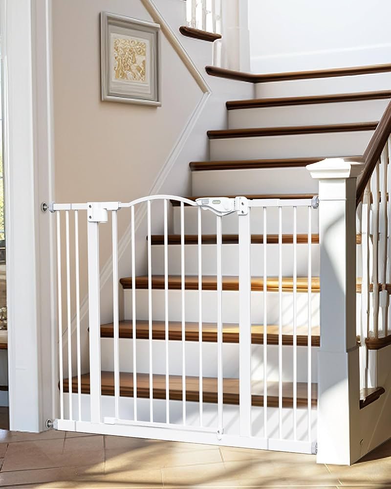 Black InnoTruth baby gate with dual-lock latch installed at the bottom of a staircase