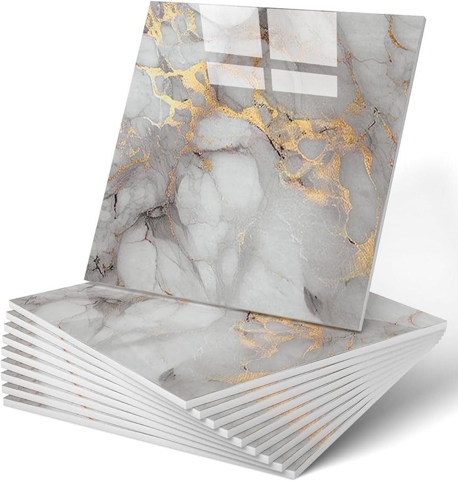 White marble tile backsplash with gray veining behind white kitchen cabinets