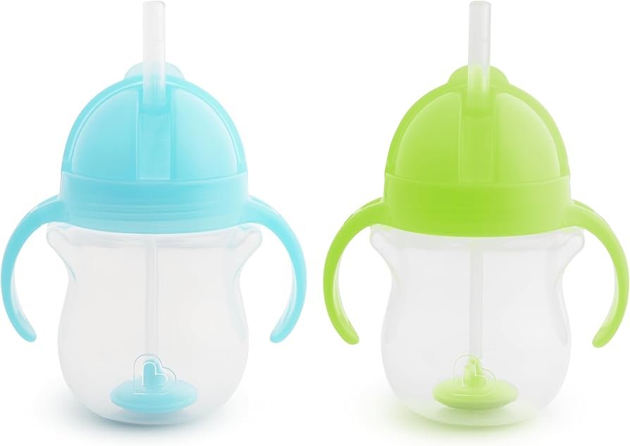 Munchkin weighted straw trainer cup with click lock lid, blue and green cups on a toddler table