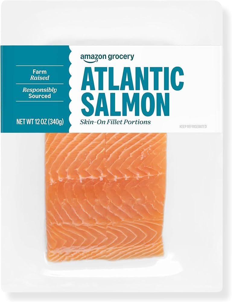 Grilled salmon fillet with lemon and herbs on plate