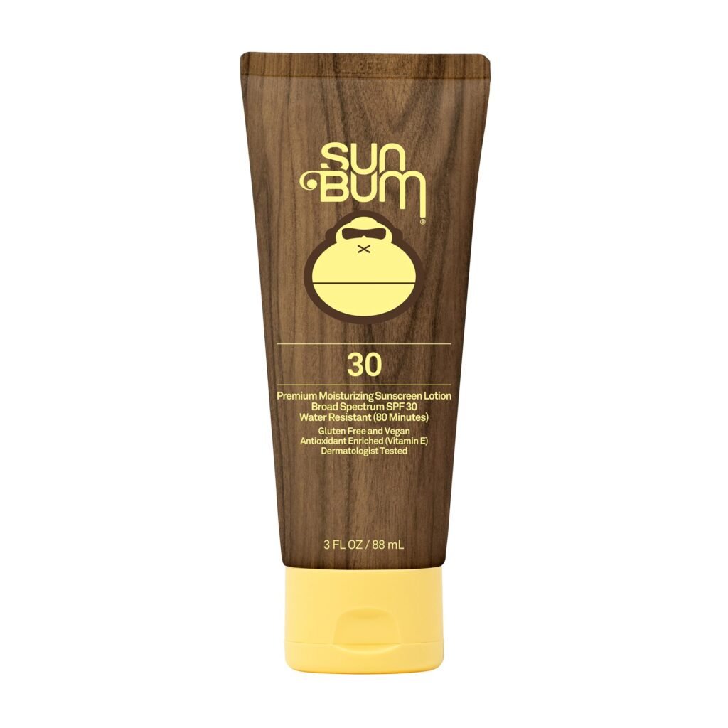 Sun Bum sunscreen lotion being applied to face outdoors
