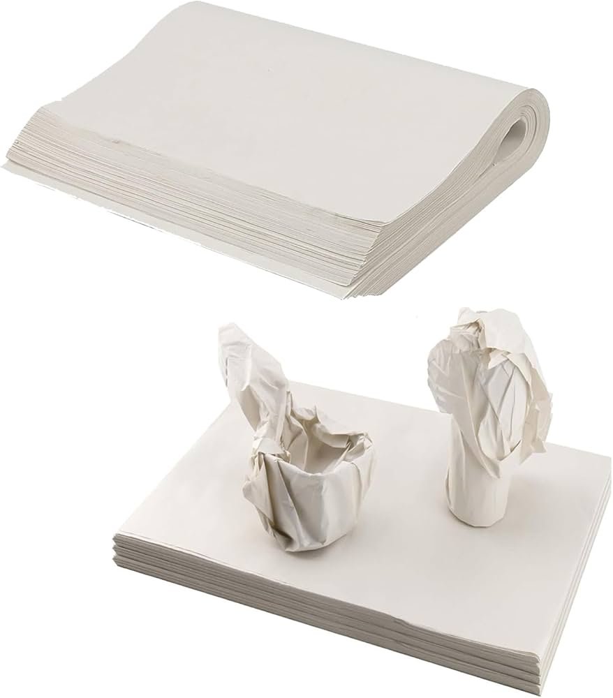 White clean packing paper wrapped around leather shoes inside a moving box