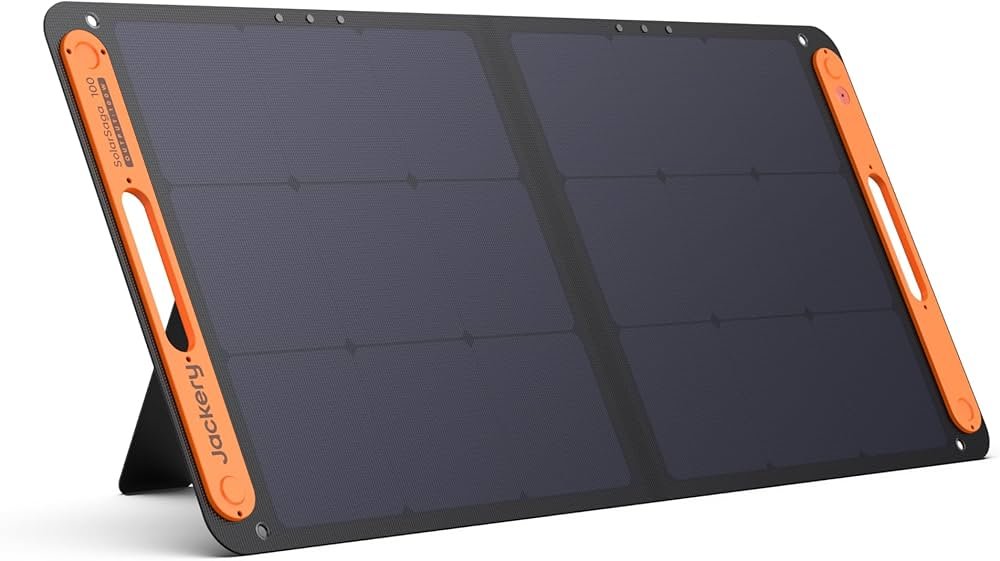 Jackery SolarSaga 100W folding solar panel set up at a campsite, charging a portable power station