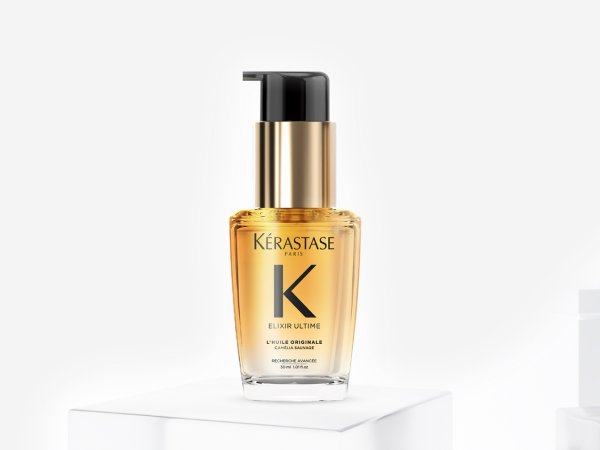 Kérastase Elixir Ultime oil bottle with glossy hair strands