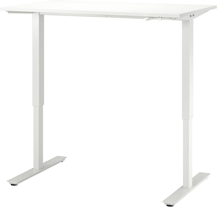 IKEA TROTTEN sit/stand desk with a clean white top, gaming monitor, keyboard, and a cable-managed setup