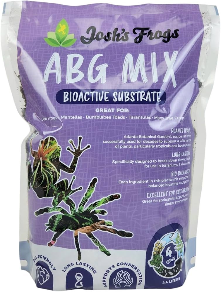 Bioactive substrate layer with leaf litter and live plants inside a ball python habitat