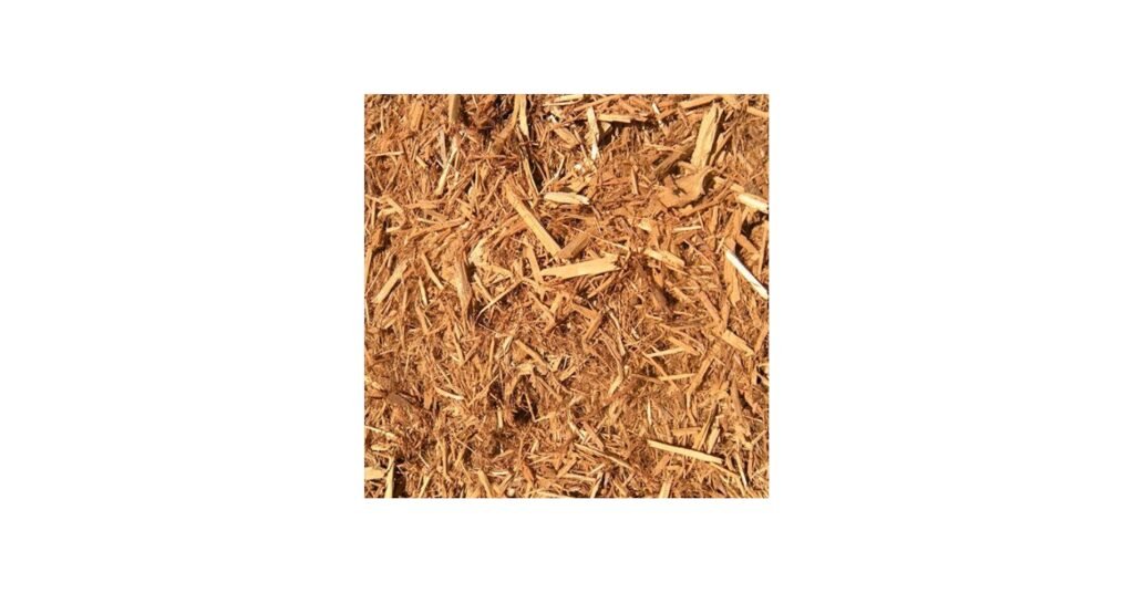 Cypress mulch bedding in a snake enclosure with dark wood chips and a center hide