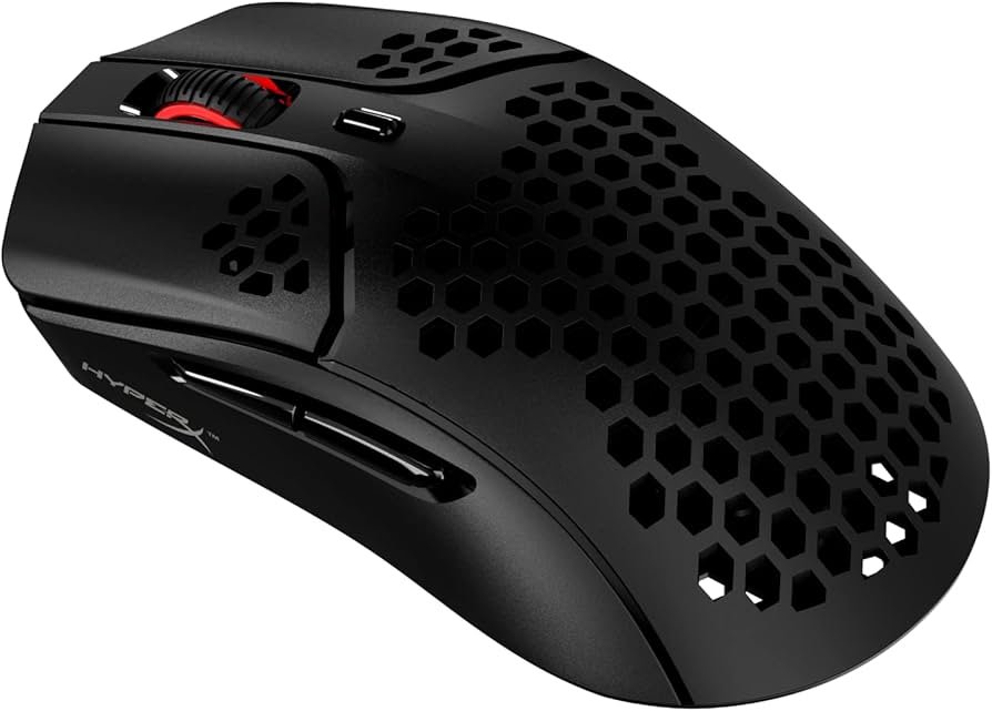 HyperX Pulsefire Haste lightweight gaming mouse on a desk near a MacBook