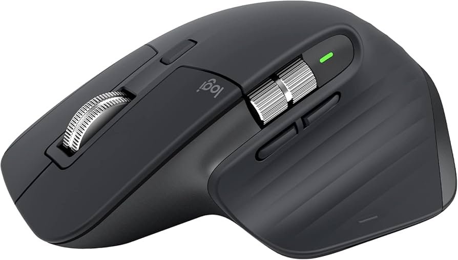 Logitech MX Master 3S wireless mouse on a desk beside a MacBook