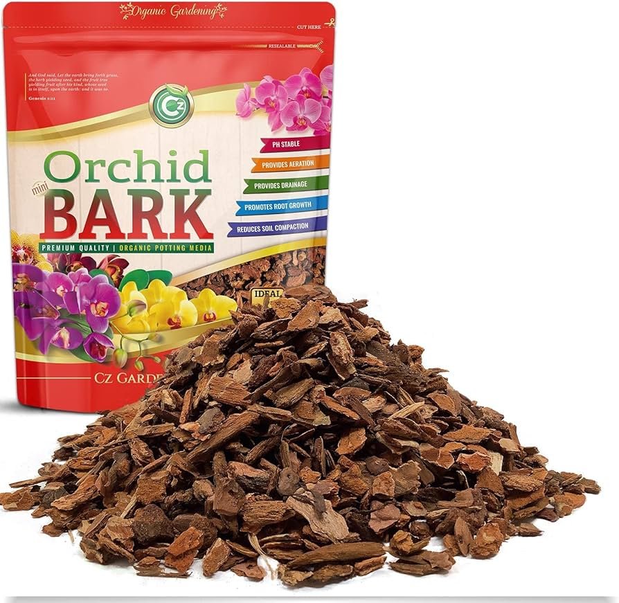 Orchid bark substrate pieces in a reptile enclosure with a water bowl and textured background