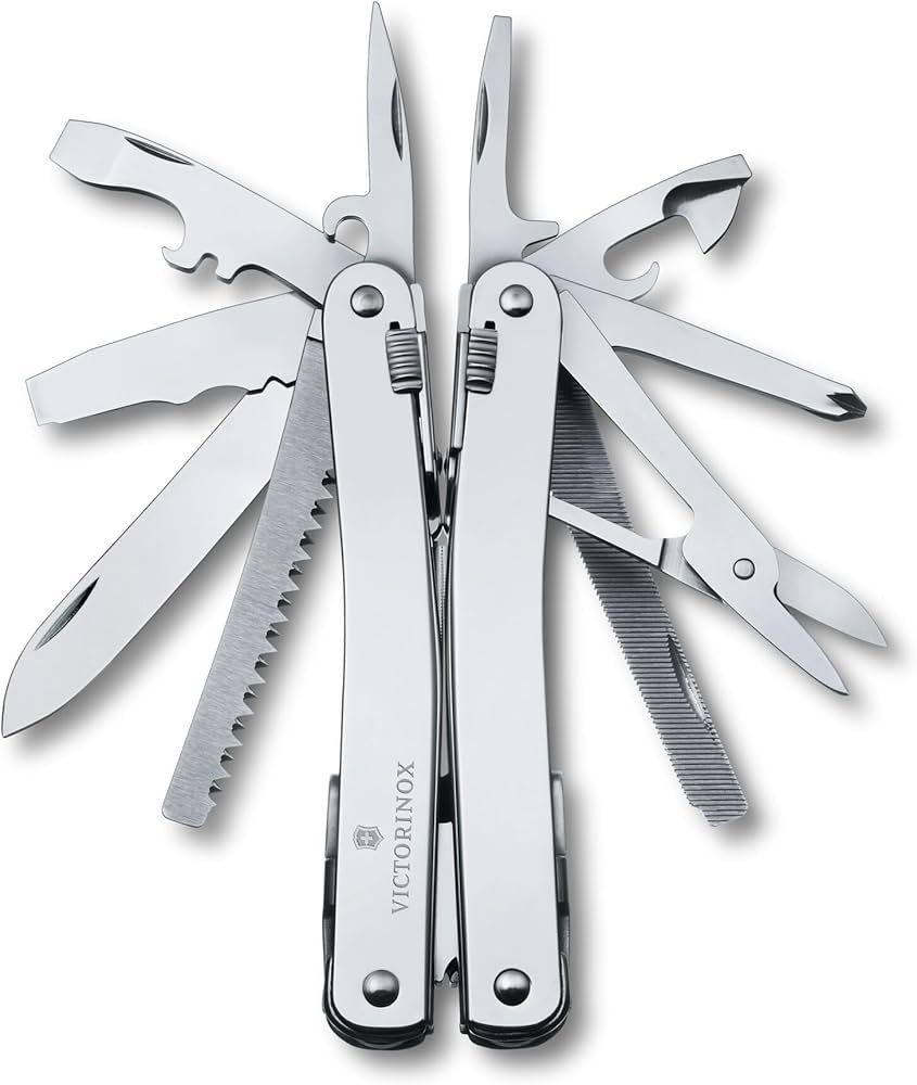 Victorinox SwissTool Spirit X open showing pliers, blade, and fold-out tools on a wooden table