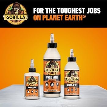 Gorilla Wood Glue bottle next to a small DIY wood project with fresh glue squeeze-out on a joint.