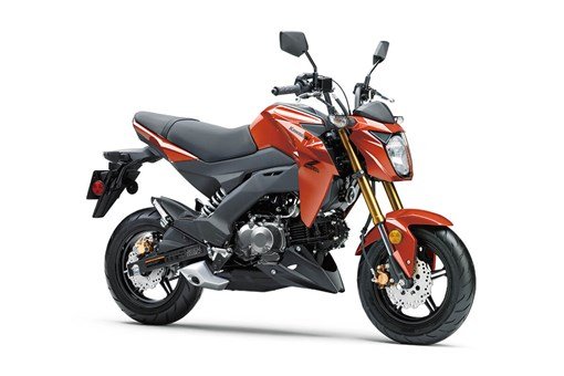 Kawasaki Z125 Pro mini bike for adults in a street setting with a sharp body design and compact seat.