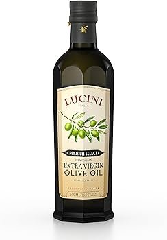 Lucini Italia extra virgin olive oil bottle near bread and tomatoes, highlighted as a peppery “best olive oil for health” option.