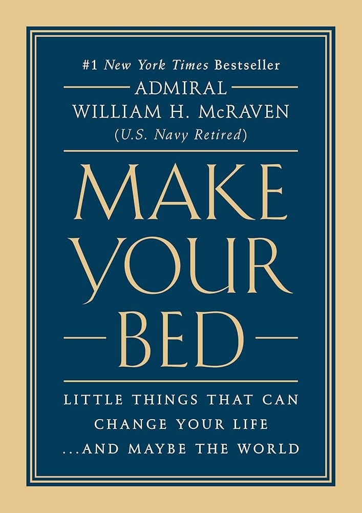 “Make Your Bed” book cover beside a neatly made bed, representing the best self-help books for men for discipline.