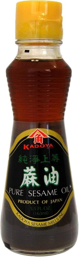 Sesame oil warmed in hands before a deep tissue-style back massage, showing a richer glide for longer strokes.