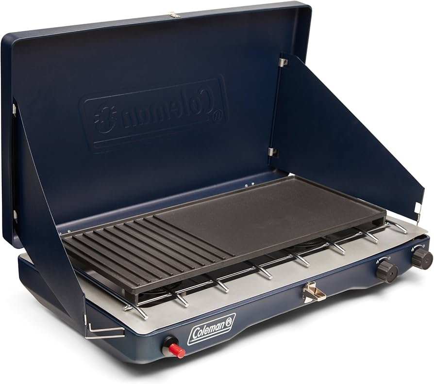 Coleman 3-in-1 camping stove with removable grill and griddle accessories, shown cooking breakfast at a campsite.