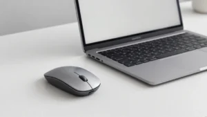 Wireless mouse placed next to a laptop on a clean desk for a best mouse for MacBook guide
